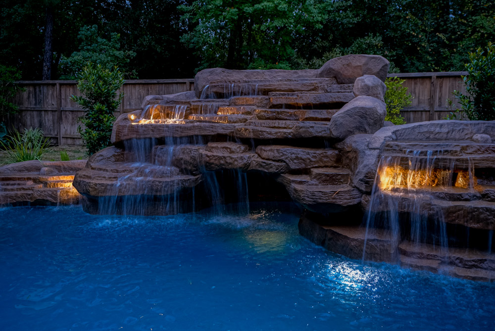 Pool water feature - stone waterfall with lighting - by Richards Houston TX