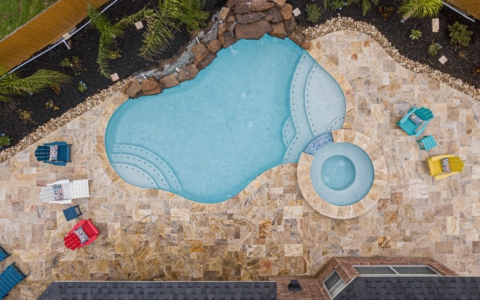 Clear pool with steps and a hot tub spa