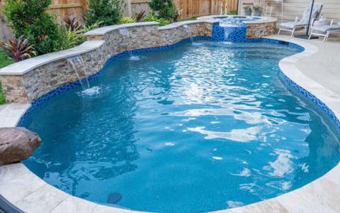 Fountains pouring into a pool with spa and plant features