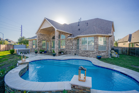 Lanterns near an outdoor pool and fountain