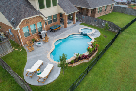 Cyan clear pool and spa in a backyard